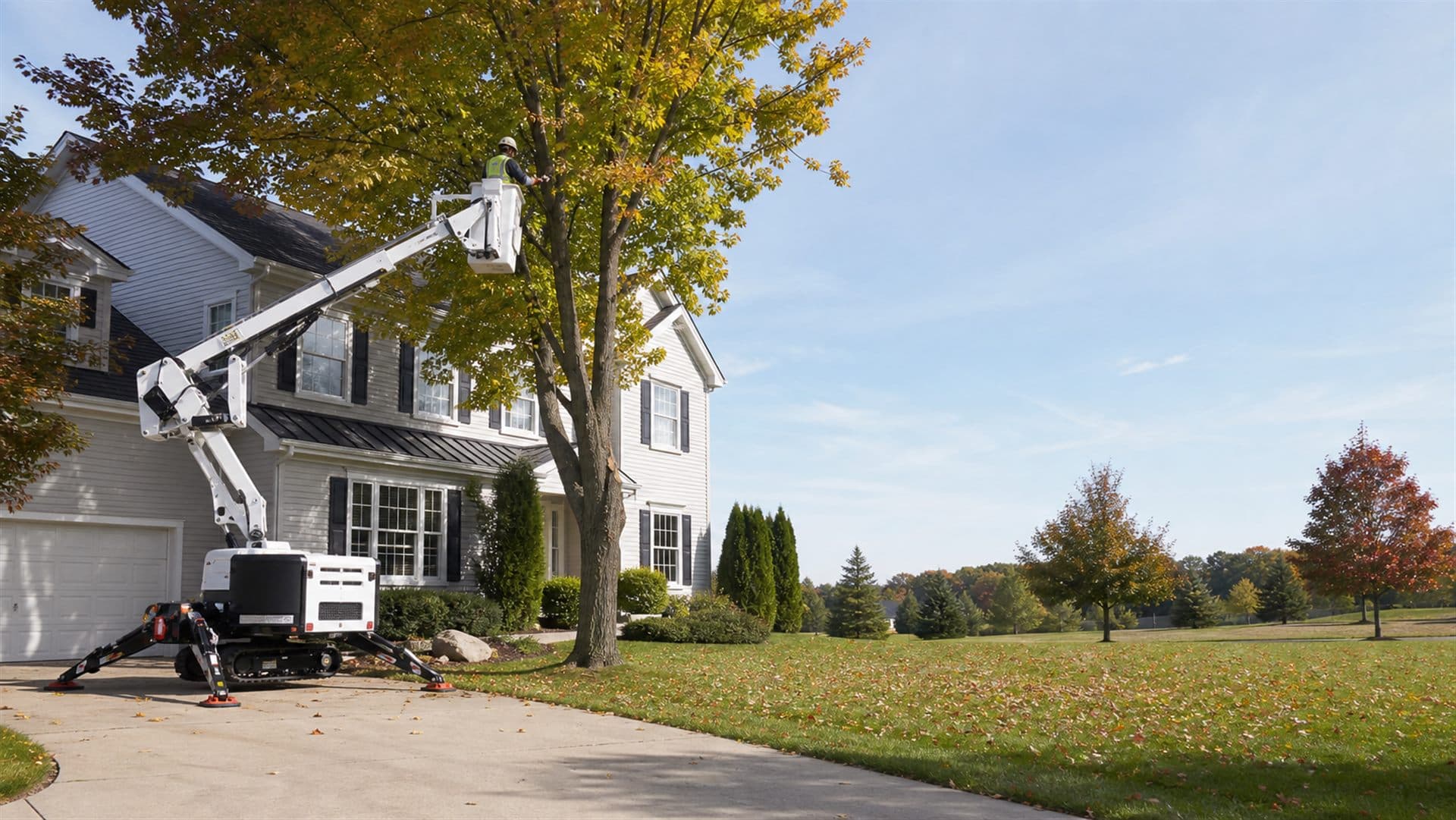 Tree-service crew preparing organized equipment beside a suburban home